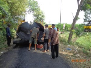 Gambar saat ketua LPMD, Sanadi S.P.d, memakai topi kuning menyaksikan pengambilan sampling matrial hotmix