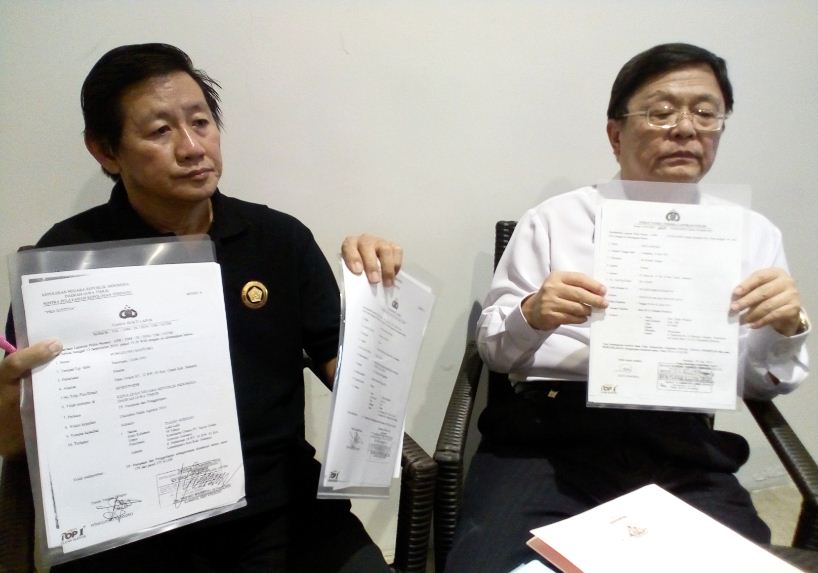 Kanan: Ponggowo Baju Putih korban penipuan, Kiri: Relasinya Ketua Persatuan Jurnalis Indonesia (PJI),saat memegang beberapa bukti lapor Polisi Di Polda Jatim dan Surat SP2HP